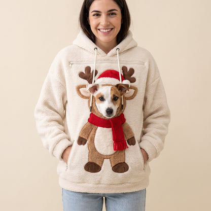 Woman wearing the cream Reindeer pet pouch hoodie with a Jack Russell peeking out of the pouch