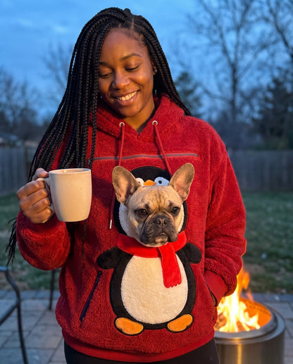 Customer outdoors at dusk in the Penguin pet pouch hoodie with a French bulldog